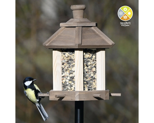 Mangeoire à oiseaux en bois avec un symbole pour l''alimentation tout au long de l''année