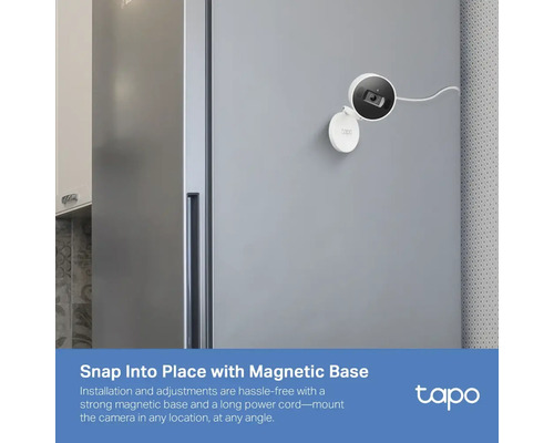 Caméra de surveillance avec base magnétique fixée sur un réfrigérateur.