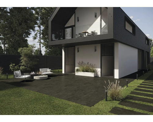 Maison moderne avec terrasse, mobilier de jardin et pelouse