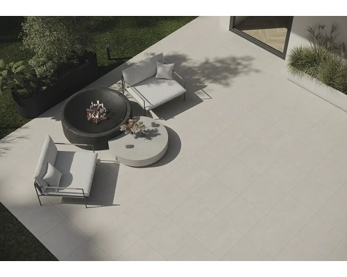 Gartenszene mit Terrassenplatten, Feuerschale und Sitzmöbeln für den Aussenbereich.