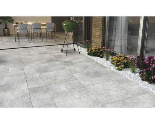 Terrasse mit Steinplatten, Grill und Sitzgruppe