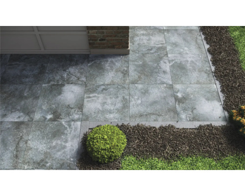 Garten mit grauen Terrassenplatten, Zierkies und Pflanzen