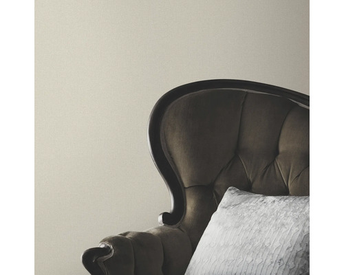 Beige Wand mit Sessel und Kissen