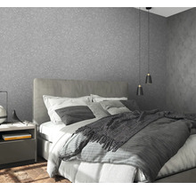 Chambre avec papier peint structuré gris, lit et table de chevet