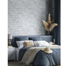 Schlafzimmer mit Bett, Nachttisch und Wandfliesen in Schuppenoptik