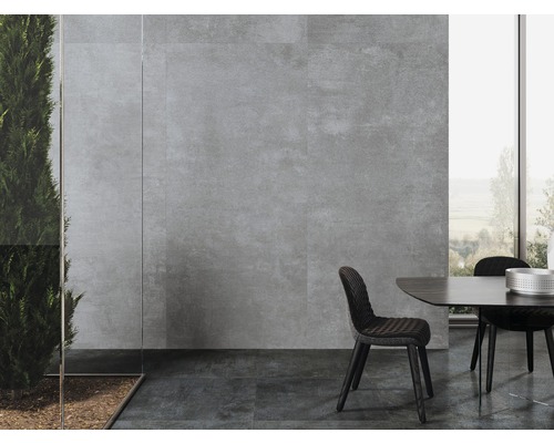 Salle à manger avec carrelage mural et au sol aspect pierre et grande fenêtre