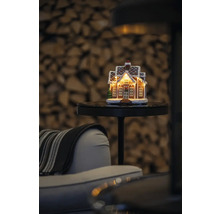Maison en pain d’épices décorative avec éclairage sur une table