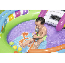 Kind im bunten Planschbecken mit Wasserrutsche und Spielbällen