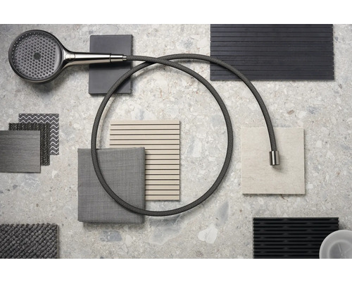 Composition de douchette à main et d''échantillons de textile et de carrelage sur une surface en pierre