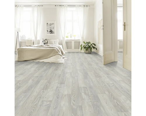 Chambre lumineuse avec parquet, lit et rideaux blancs