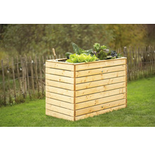 Jardinière surélevée en bois avec salade et outils de jardinage dans le jardin
