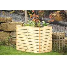 Jardinière surélevée en bois avec des plants de salade dans le jardin