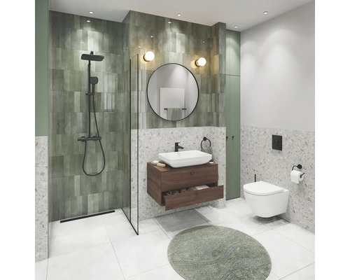 Salle de bain moderne avec douche, lavabo, miroir et toilettes.