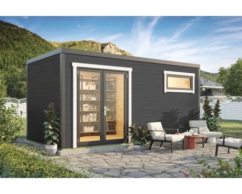 Abri de jardin avec porte vitrée et fenêtre, entouré de mobilier de jardin sur une terrasse en pierre