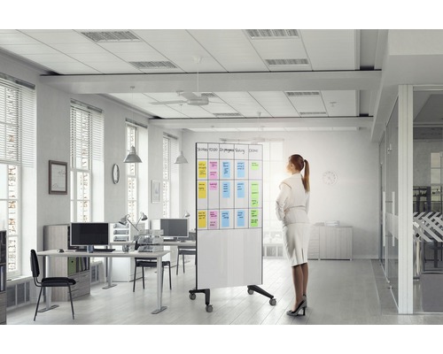 Bureau lumineux avec des bureaux, des chaises de bureau et un tableau blanc mobile avec des notes