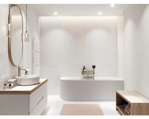 Helles Badezimmer mit Badewanne, Waschtisch, Spiegel und sechseckigen Fliesen