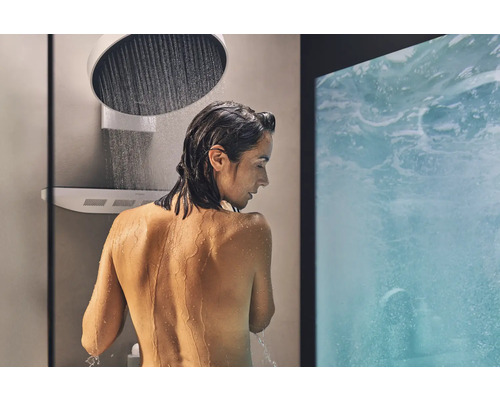 Frau unter einer Regendusche im Badezimmer