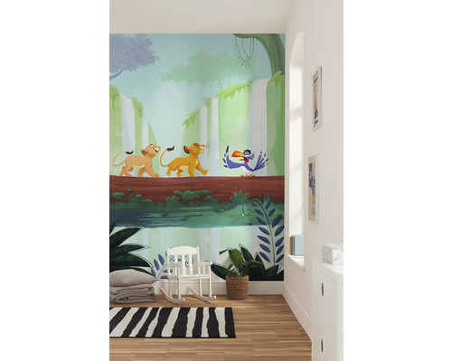 Scène avec une décoration murale du film Le Roi Lion dans une pièce avec un fauteuil à bascule, un tapis et une plante