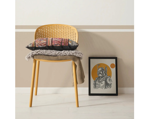 Dekoratives Interieur mit Stuhl, Kissen und gerahmtem Bild