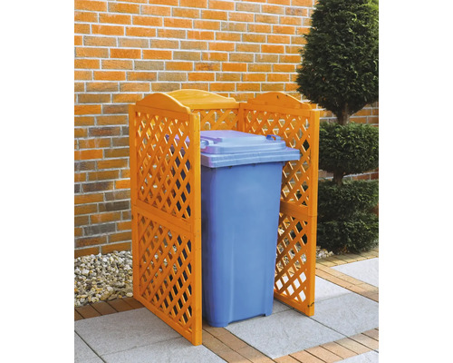 Cache-conteneur en bois avec poubelle devant un mur de briques