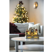 Dekorative hölzerne Weihnachtsbeleuchtung mit Riesenrad auf einem Tisch, im Hintergrund ein Weihnachtsbaum