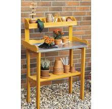 Table de rempotage jaune en bois avec plan de travail en métal et deux étagères