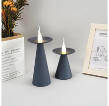 Zwei graue LED-Kerzenleuchten auf einem Tisch, dekorative Elemente im Hintergrund