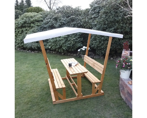 Table de pique-nique en bois avec bancs et protection solaire dans le jardin.