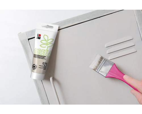 Pot de peinture alkyde verte et pinceau lors de la peinture d''une armoire métallique