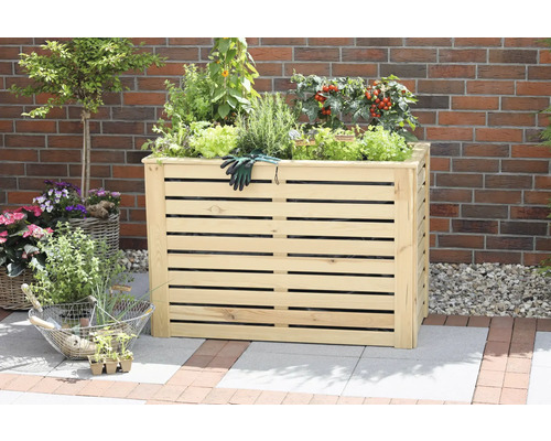 Jardinière surélevée en bois avec diverses plantes et gants de jardinage