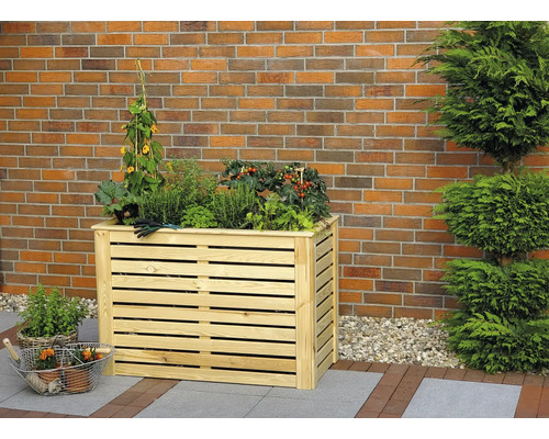 Jardinière surélevée en bois avec diverses plantes et herbes