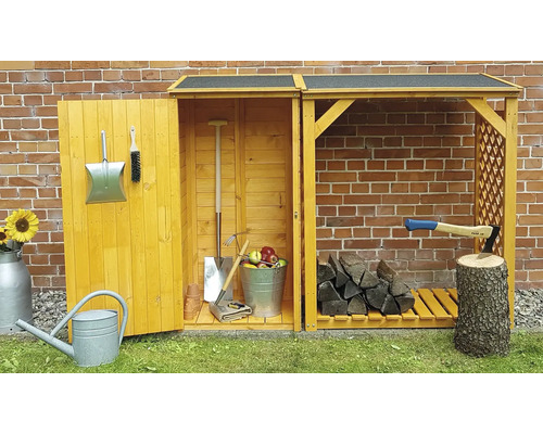 Abri de jardin avec outils, bois et accessoires devant un mur de briques