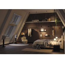Chambre mansardée avec lit, fenêtre de toit et lambris en bois