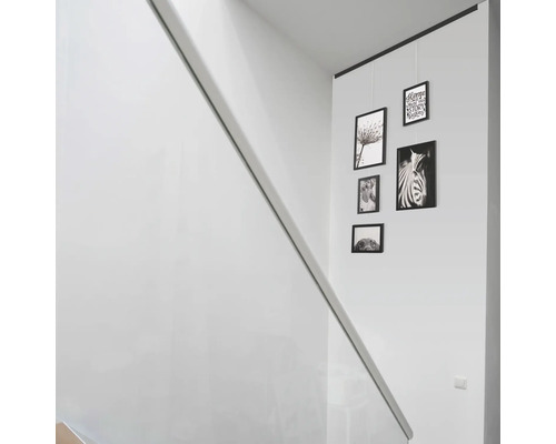 Szene eines Treppenhauses mit Bilderleisten und Fotos an einer Wand.