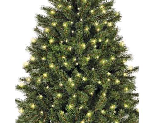 Gros plan sur un sapin de Noël artificiel vert avec éclairage