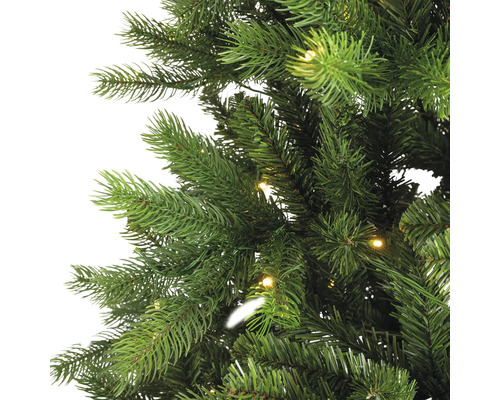 Gros plan d'un sapin de Noël artificiel avec éclairage.