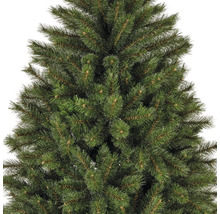 Gros plan d'un sapin de Noël artificiel avec des aiguilles vertes
