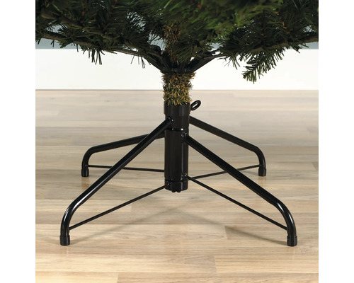 Gros plan d'un arbre de Noël artificiel avec un pied en métal noir