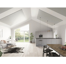 Salon lumineux avec panneaux acoustiques au plafond, canapé, cuisine et coin repas.