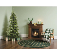 Salon avec sapin de Noël, cadeaux, cheminée et fauteuil
