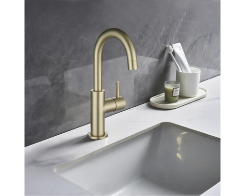 Goldene Armatur mit rundem Auslauf und seitlichem Hebel am Waschbecken