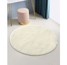 Tapis rond et clair dans une pièce avec tabouret et table