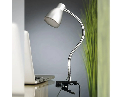 Lampe à pince avec bras flexible sur une table à côté d''un ordinateur portable.