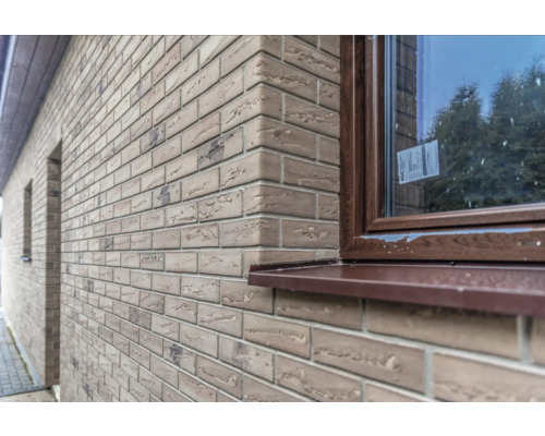 Extérieur d''une maison avec une façade en plaquettes de parement et une fenêtre