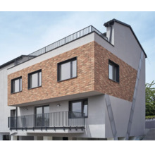 Bâtiment moderne avec façade en briques, fenêtres et balcon