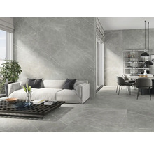 Salon moderne avec des carreaux de marbre gris sur les murs et le sol, canapé et table à manger