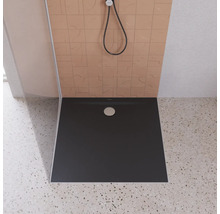 Receveur de douche dans une salle de bains avec pommeau de douche et carrelage