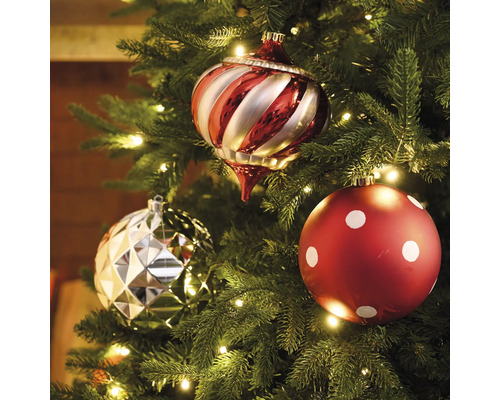 Trois boules de Noël sur un sapin de Noël avec éclairage.