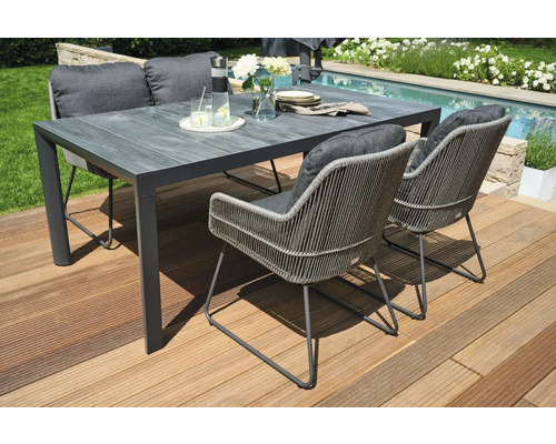 Ensemble de salle à manger d'extérieur avec table, chaises et coussins sur une terrasse