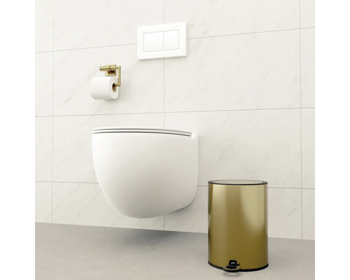 Salle de bains moderne avec WC suspendu, porte-papier toilette et poubelle à pédale